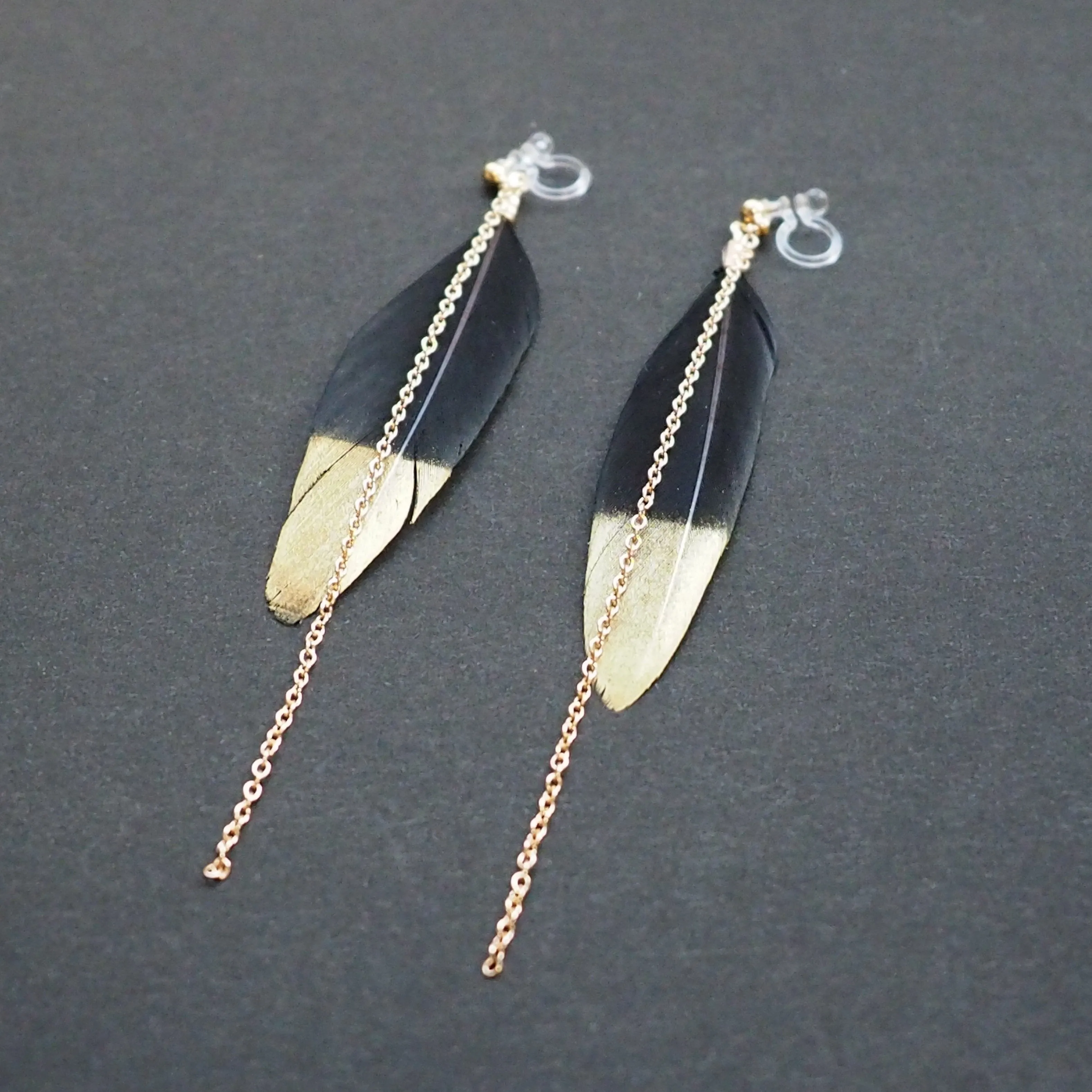 Gold painted black feather invisible clip on earrings