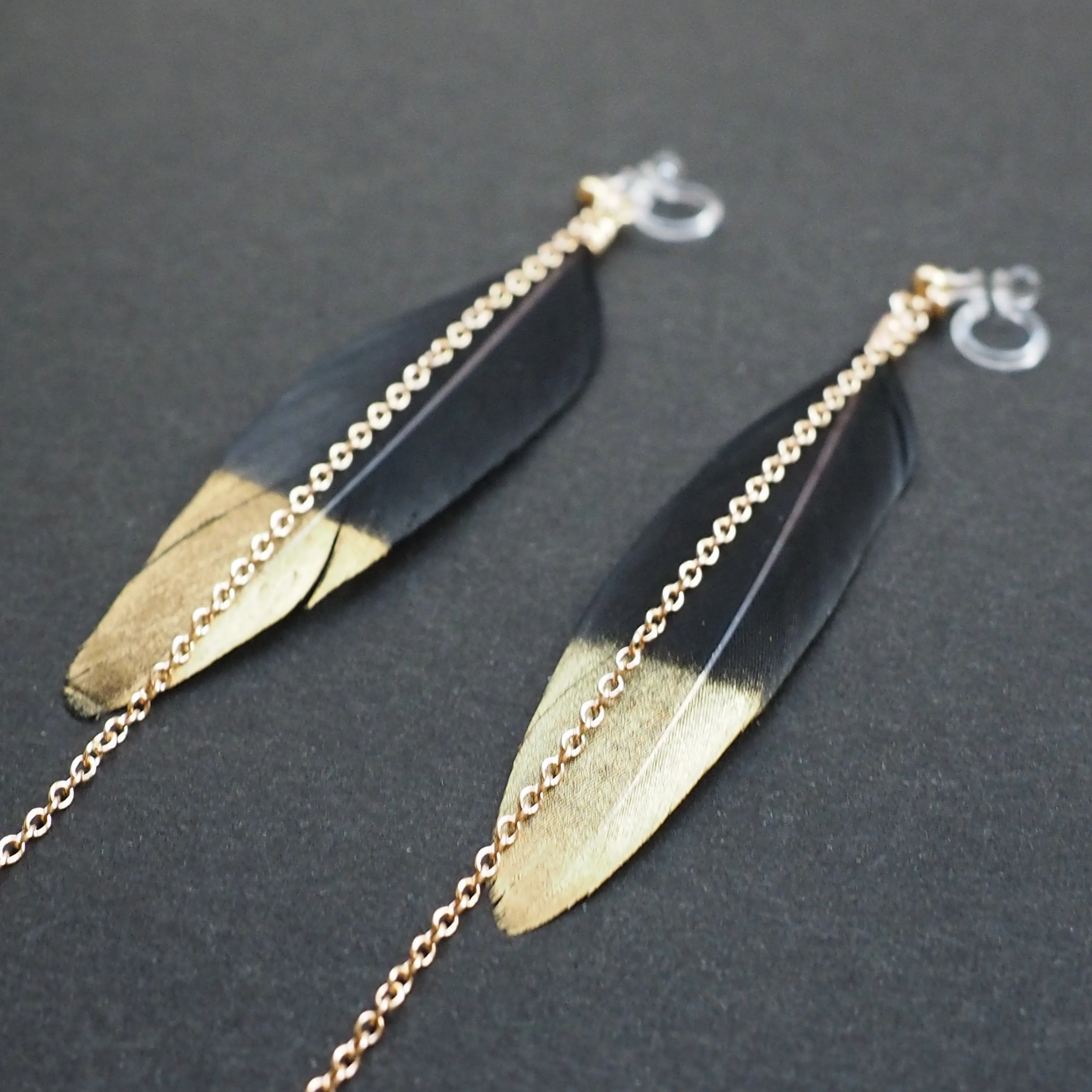 Gold painted black feather invisible clip on earrings