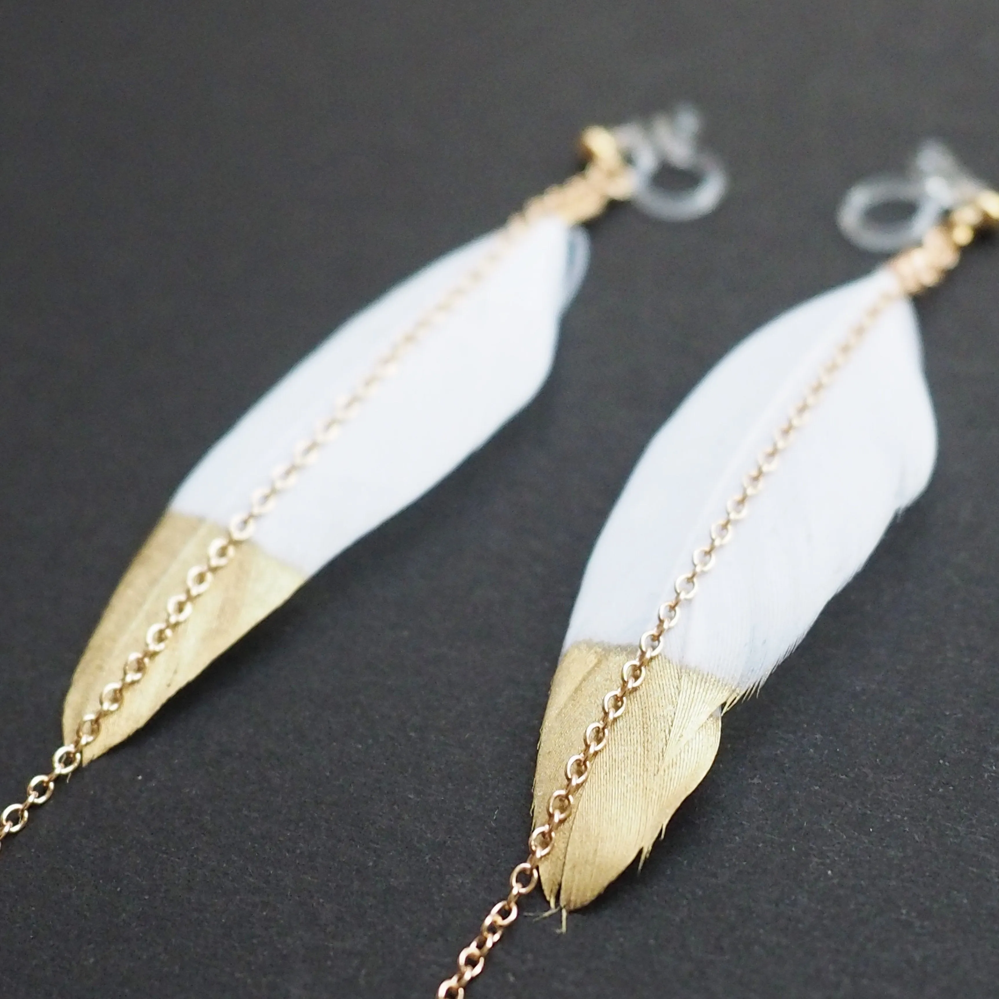 Gold painted white feather invisible clip on earrings