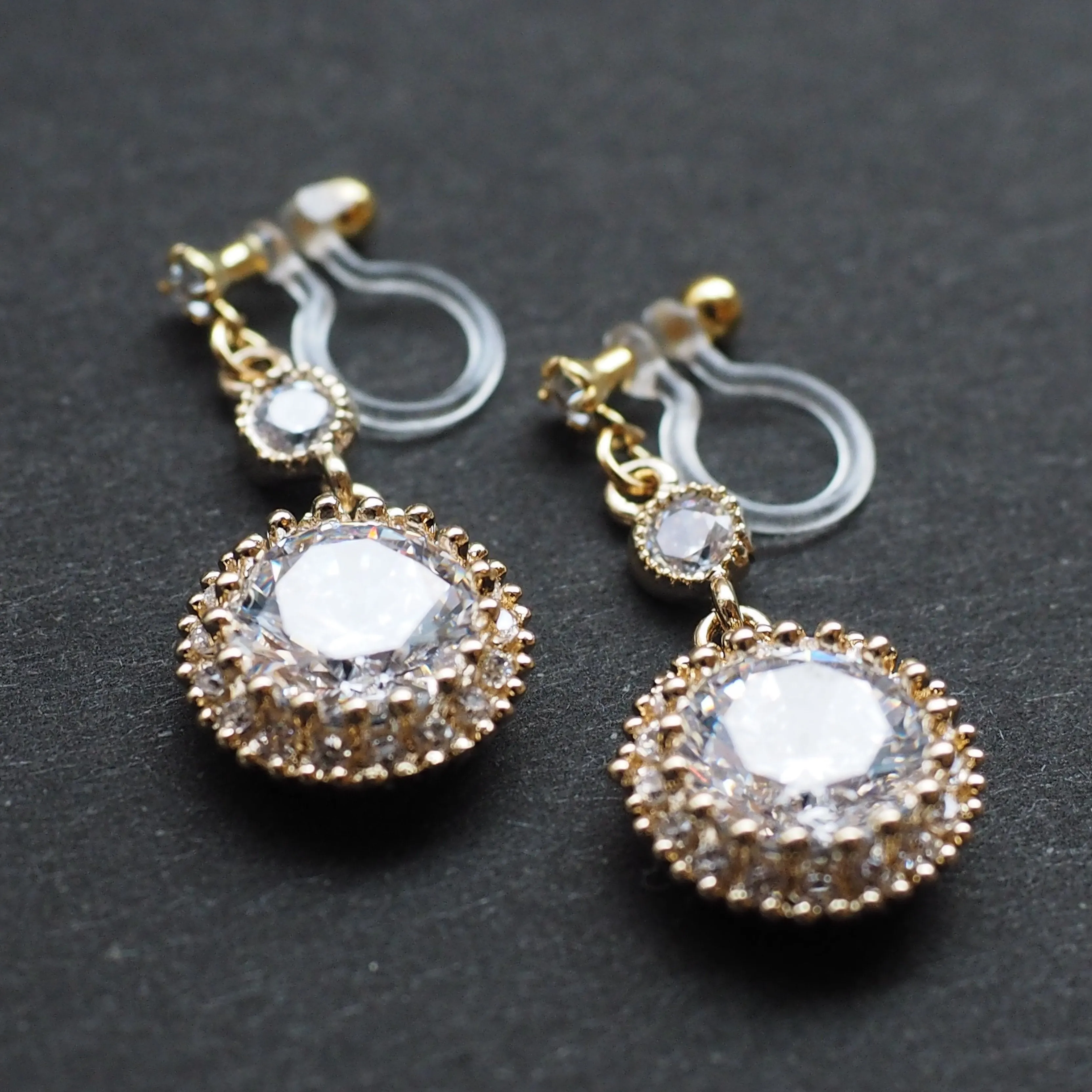 Round cubic zirconia invisible clip on earrings ( gold tone )